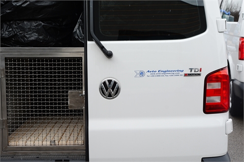 Vehicle, trailer and a cage for transportation of service dogs