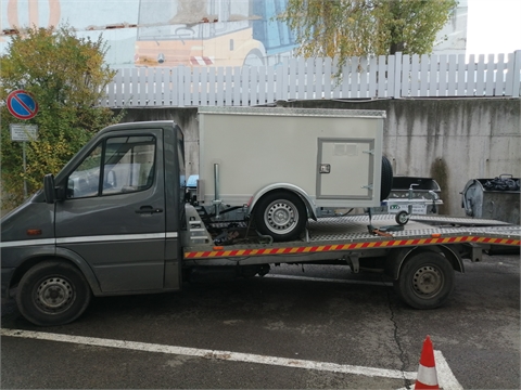 Vehicle, trailer and a cage for transportation of service dogs