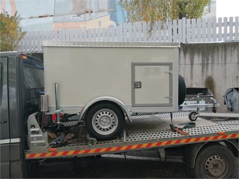 Vehicle, trailer and a cage for transportation of service dogs