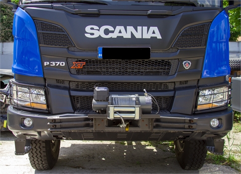 Truck with winch, on-board superstructure and hydraulic crane