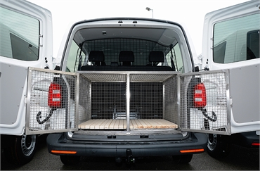 Specialized vehicles and trailers for canine transportation