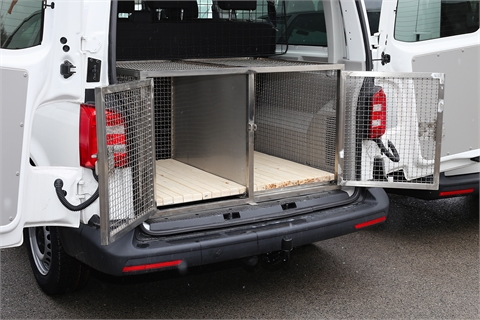 Vehicle, trailer and a cage for transportation of service dogs